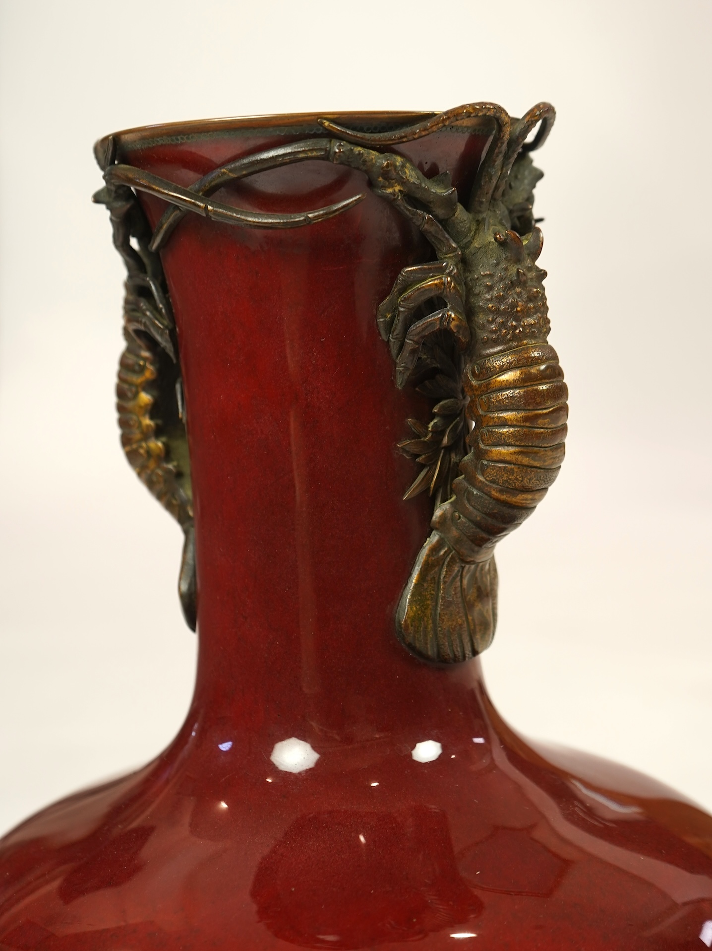 An unusual Japanese sang-de-boeuf ground cloisonné enamel and gilt metal mounted vase